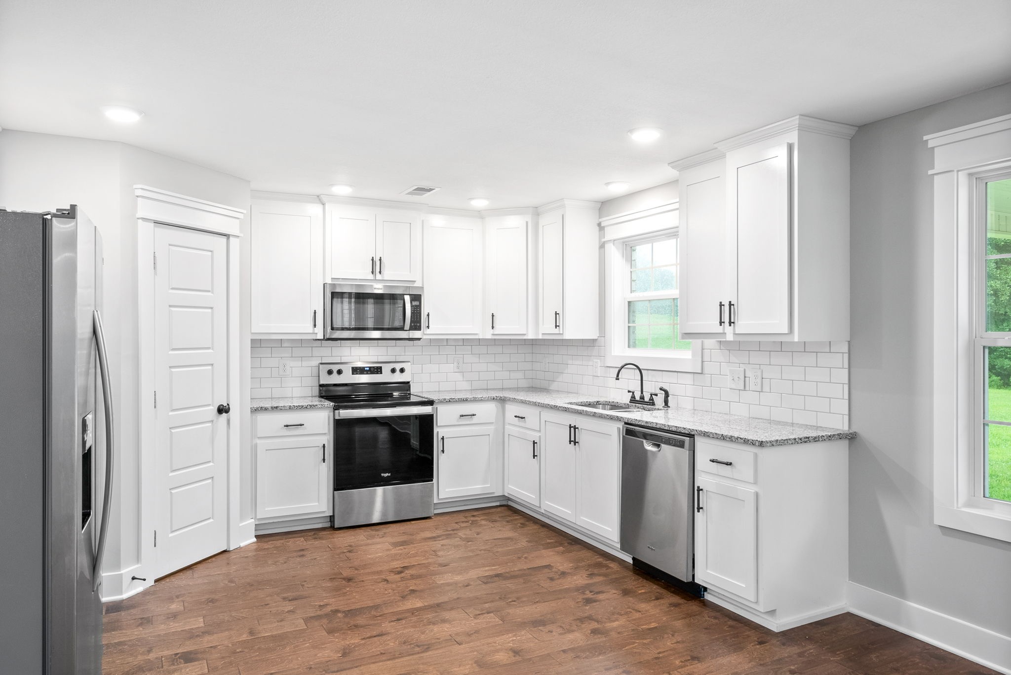 1385 L Bumpus Road Clarksville, TN 37040 - Photo 12 of 28 a kitchen with stainless steel appliances granite countertop a stove and a refrigerator