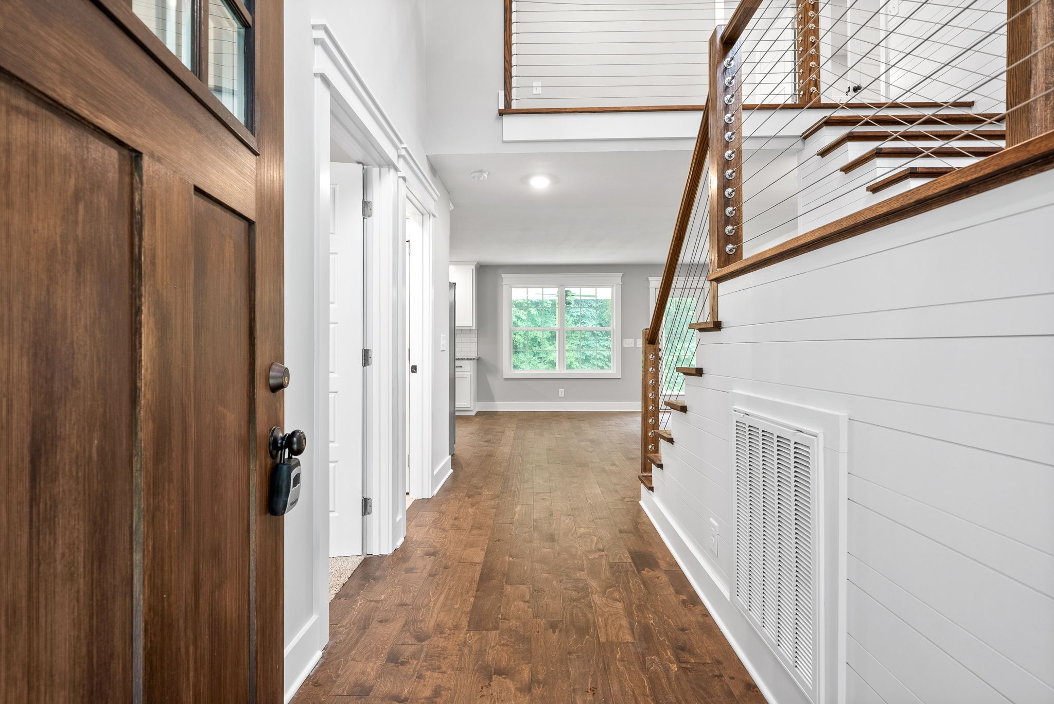 1385 L Bumpus Road Clarksville, TN 37040 - Photo 3 of 28 a view of a hallway with wooden floor and staircase