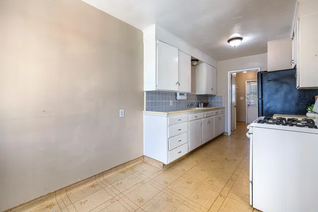 a kitchen with refrigerator a stove a sink and a refrigerator