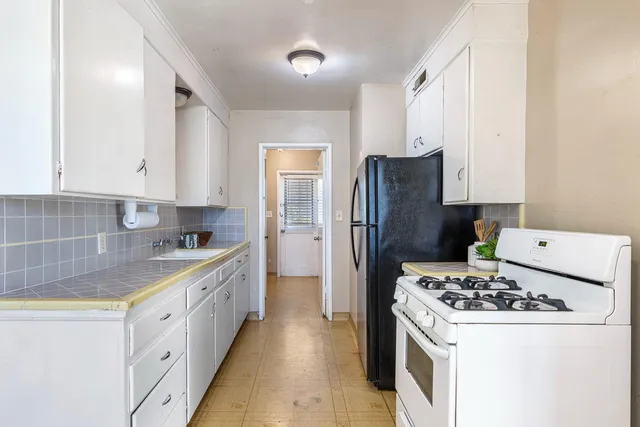 a kitchen with a stove and a refrigerator