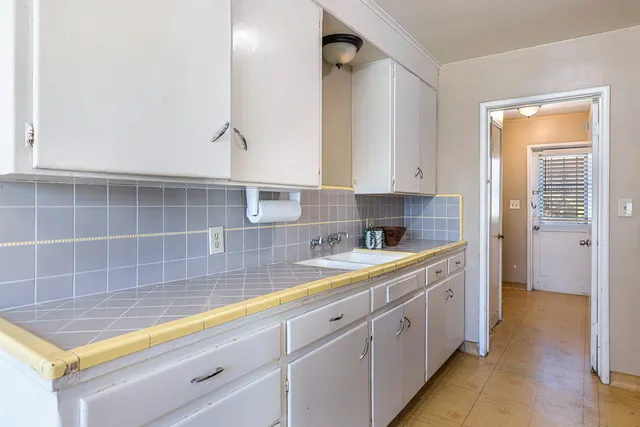a bathroom with a double vanity sink a mirror and a bathtub