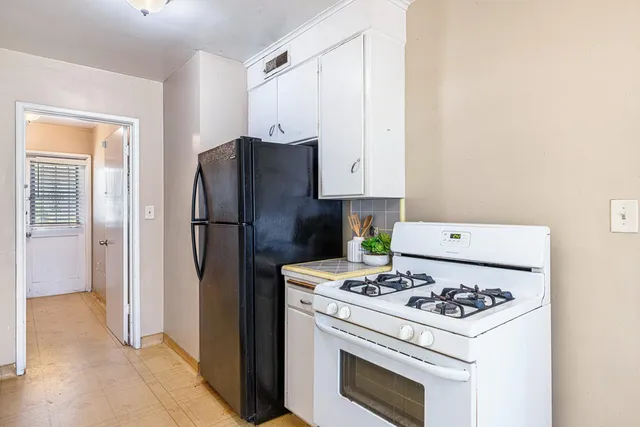 a kitchen with granite countertop a stove and a sink