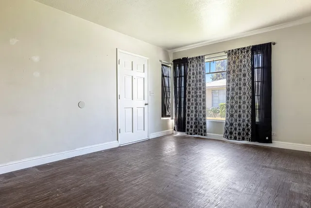 a living room with furniture and a painting on the wall
