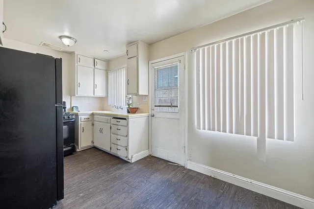 an aerial view of a house with a garden and lake view