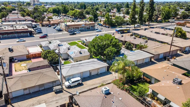 an aerial view of multiple houses with yard