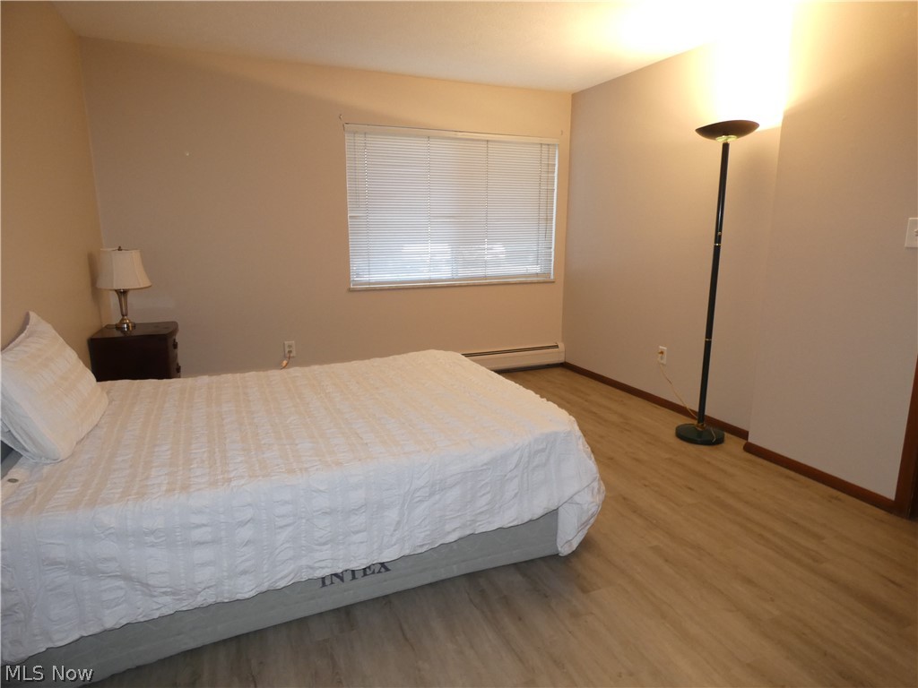Master Bedroom with recently installed luxury vinyl plank flooring and fresh paint.