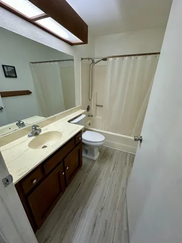 a bathroom with a double vanity sink toilet and shower