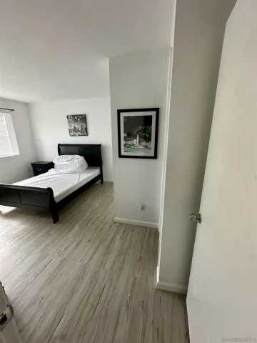 a bedroom with a bed and a view of kitchen