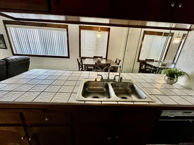 a view of a room with furniture and large windows