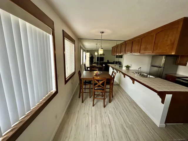 an open kitchen with granite countertop lots of counter top space and wooden floor