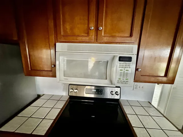 a stove top oven sitting inside of a kitchen
