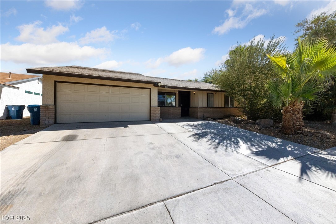 2637 Rialto Road Las Vegas, NV 89108 - Photo 1 of 22 View of front facade featuring an attached garage, driveway, and brick siding