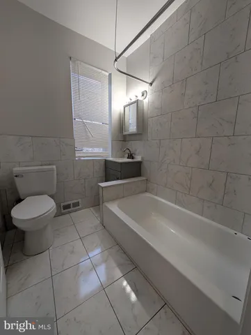 a bathroom with a bathtub and a toilet