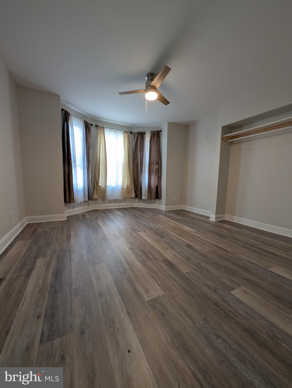 1327 North Wanamaker Street Philadelphia, PA 19131 - Photo 7 of 14 an empty room with wooden floor and windows