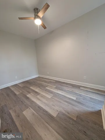 a view of a room with a ceiling fan and a window