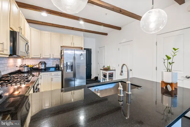 a kitchen with refrigerator and stove