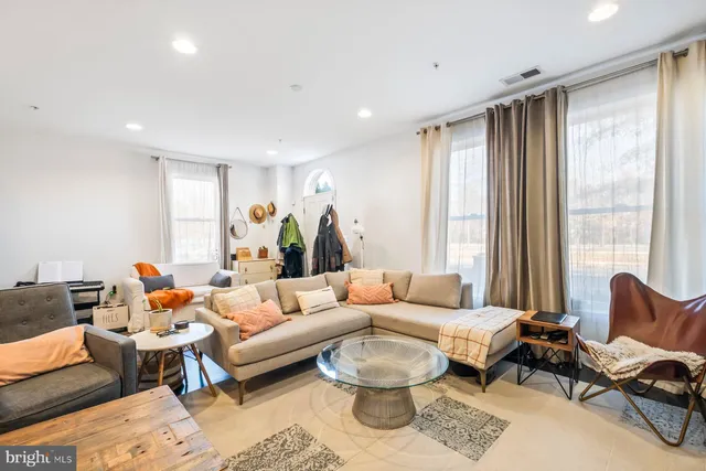 a living room with furniture and a large window