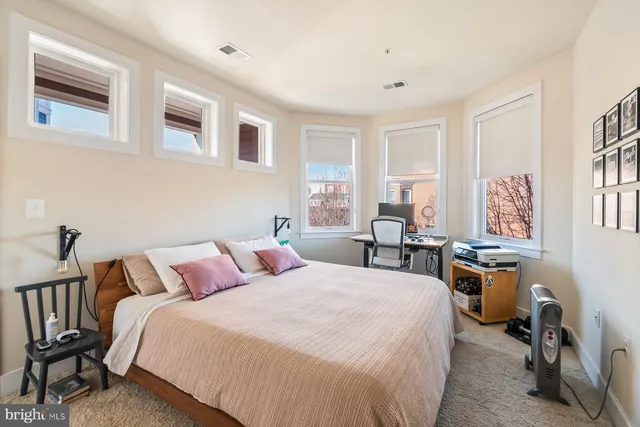 a bedroom with a bed and a table in it