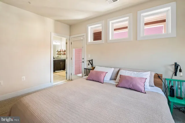 a bedroom with a bed and a painting on the wall