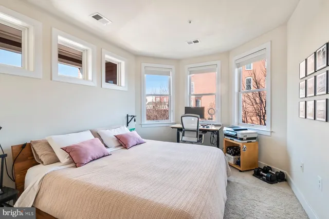 a bedroom with a bed a table and a window