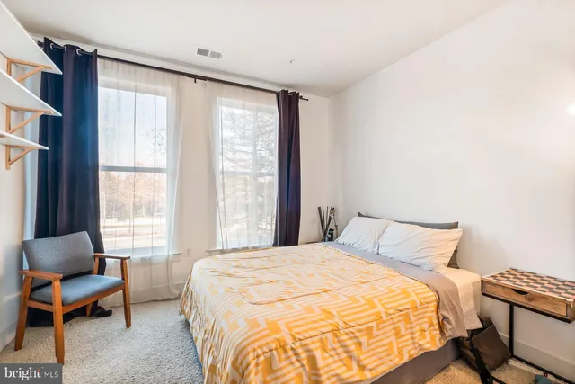 a bedroom with a bed and a chair