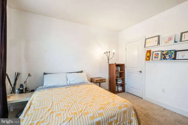 a bedroom with a bed and a book shelf