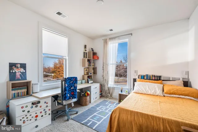 a bedroom with a bed and a large window