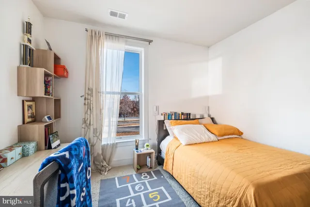 a bedroom with a bed and a window