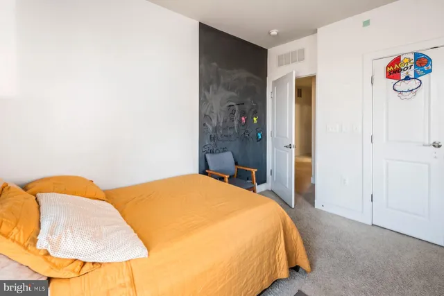 a bed room with a bed and a chair