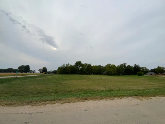 a view of a field with an ocean
