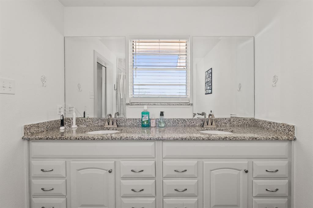 9778 Highway 11 Whitewright, TX 75491 - Photo 13 of 37 a bathroom with a granite countertop sink and a mirror