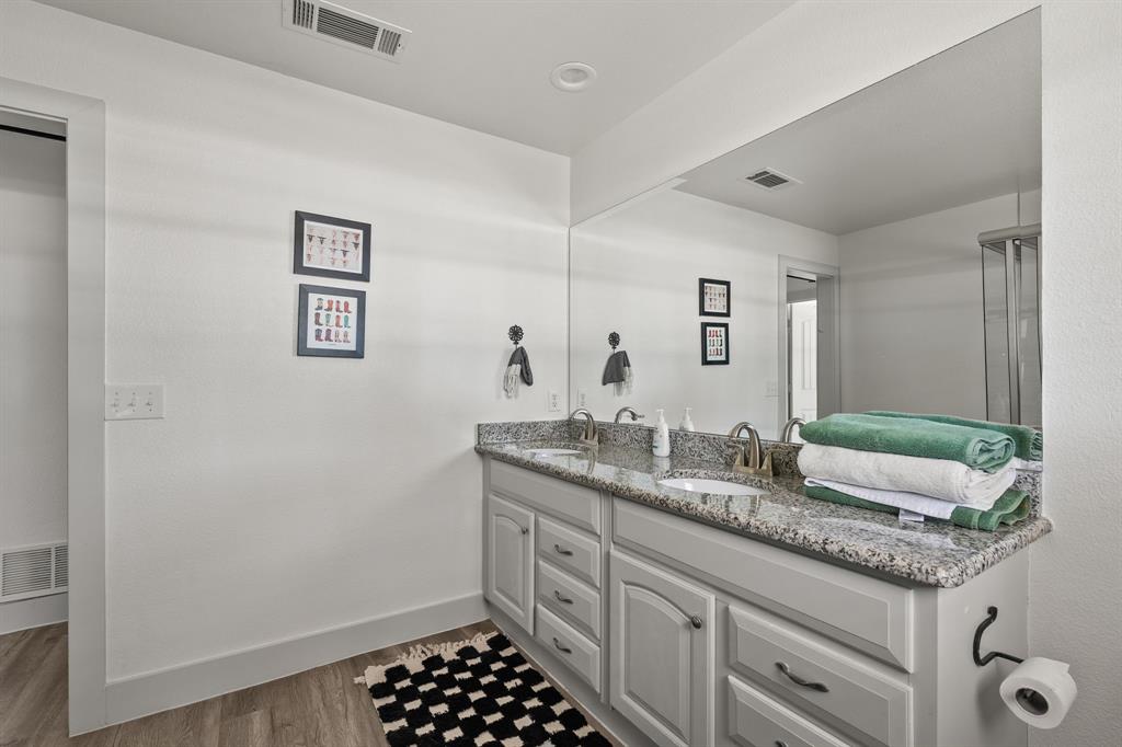9778 Highway 11 Whitewright, TX 75491 - Photo 15 of 37 a spacious bathroom with a granite countertop sink and a mirror