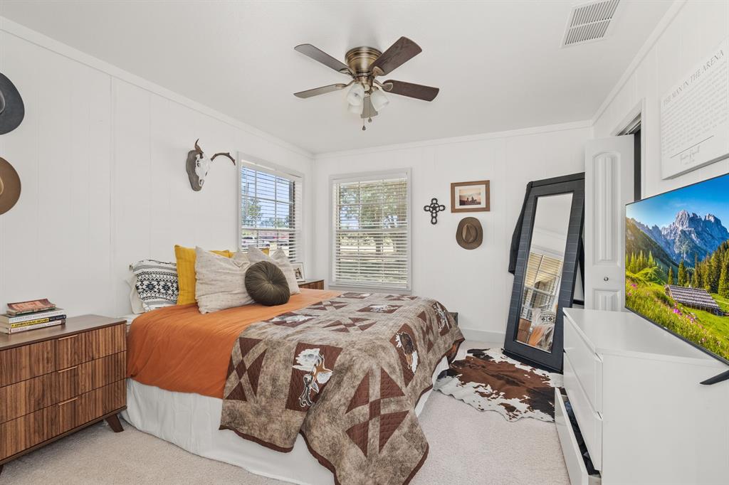 9778 Highway 11 Whitewright, TX 75491 - Photo 18 of 37 a bedroom with a bed and window