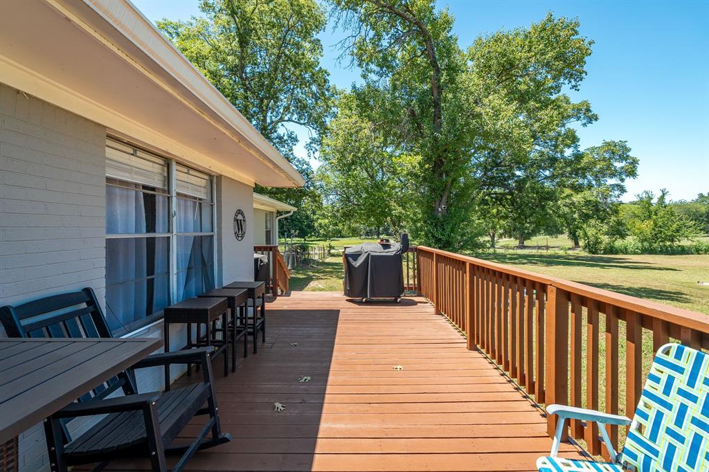 9778 Highway 11 Whitewright, TX 75491 - Photo 32 of 37 a balcony with wooden floor and outdoor seating
