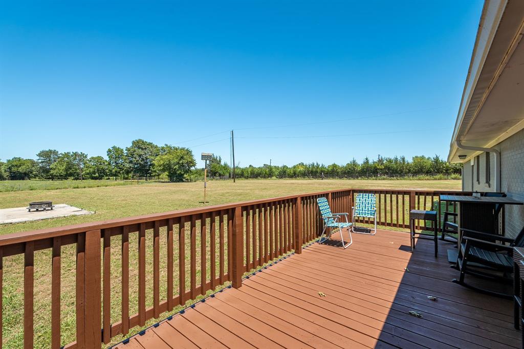 9778 Highway 11 Whitewright, TX 75491 - Photo 33 of 37 a view of wooden deck with a patio