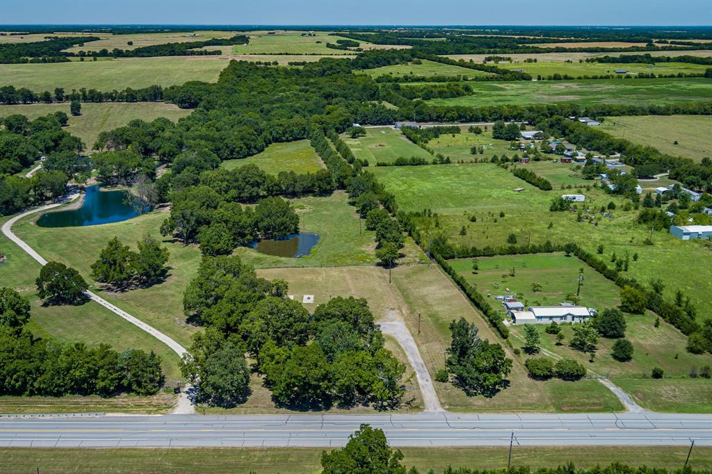 9778 Highway 11 Whitewright, TX 75491 - Photo 7 of 37 an aerial view of a golf course with a yard