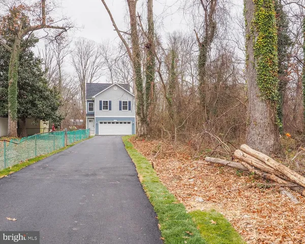 a view of a house with a yard covered with snow in the background