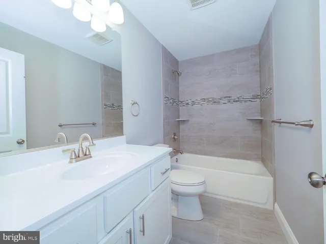 a bathroom with a sink a toilet and a bathtub