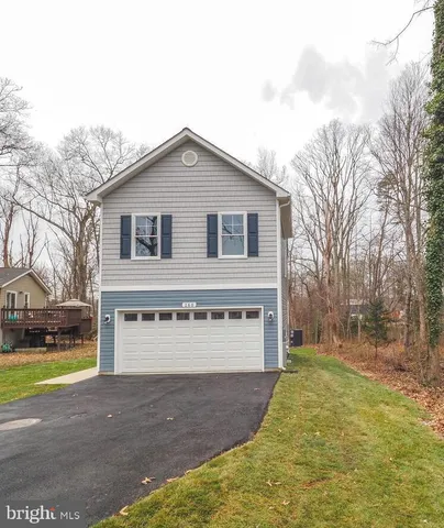a view of a house with a yard and garage