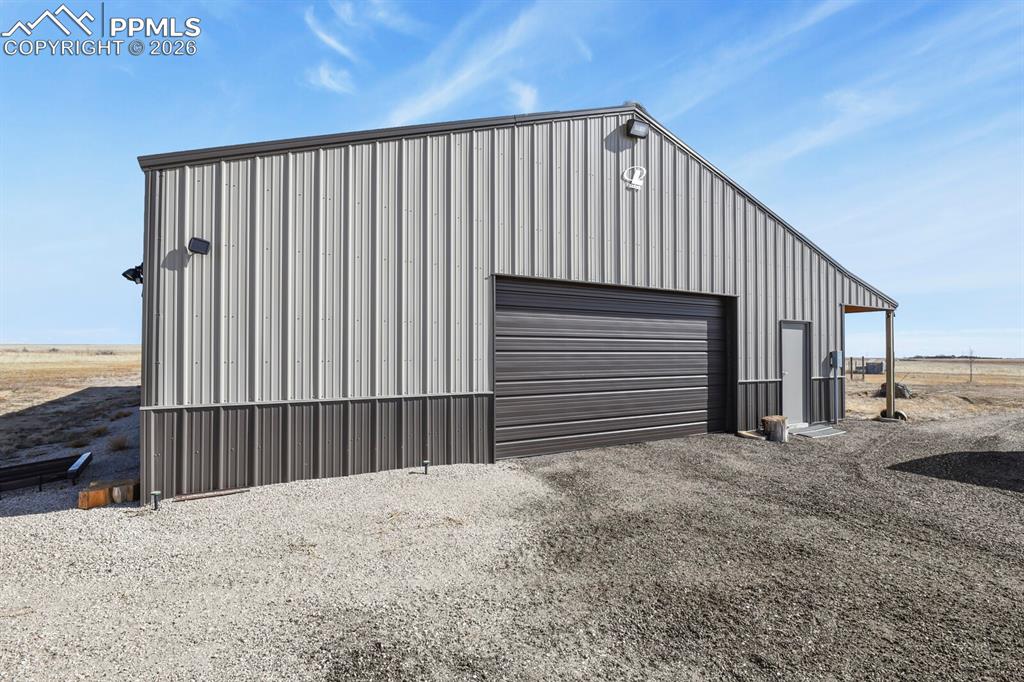 5895 Bar 10 Road Colorado Springs, CO 80928 - Photo 23 of 50 a view of a house with wooden fence