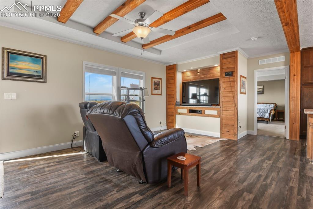 5895 Bar 10 Road Colorado Springs, CO 80928 - Photo 3 of 50 a living room with furniture and a wooden floor