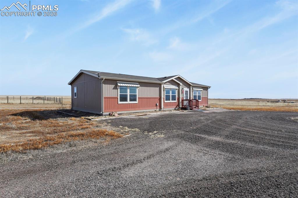 5895 Bar 10 Road Colorado Springs, CO 80928 - Photo 32 of 50 a house with trees in front of it