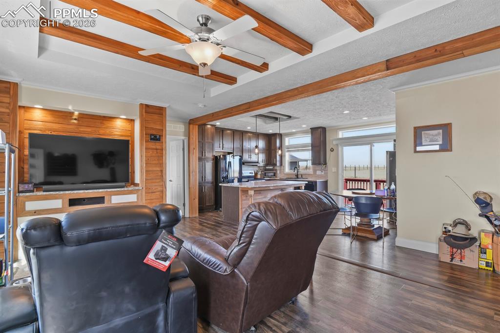 5895 Bar 10 Road Colorado Springs, CO 80928 - Photo 4 of 50 a living room with furniture and a flat screen tv