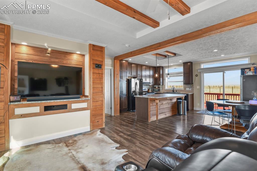 5895 Bar 10 Road Colorado Springs, CO 80928 - Photo 5 of 50 a living room with furniture and a kitchen view