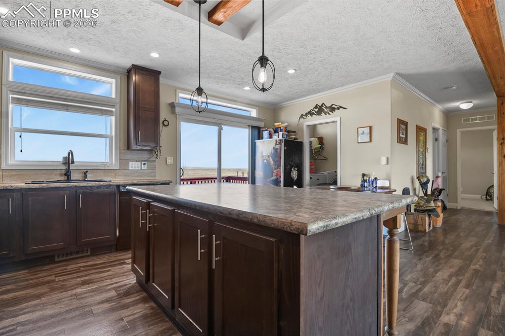 5895 Bar 10 Road Colorado Springs, CO 80928 - Photo 9 of 50 a kitchen with lots of counter space and a sink