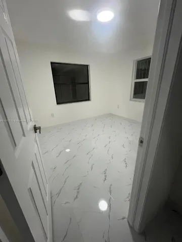 a spacious bathroom with a sink a toilet and a mirror