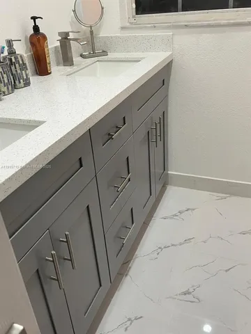 a bathroom with a sink and mirror