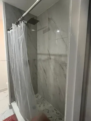 a bathroom with a shower and a toilet