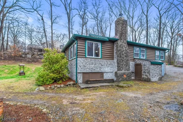 a front view of a house with a garden and yard