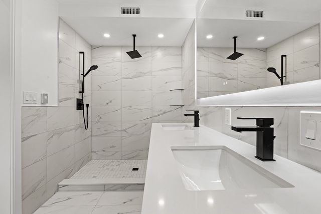 a bathroom with a shower and a sink